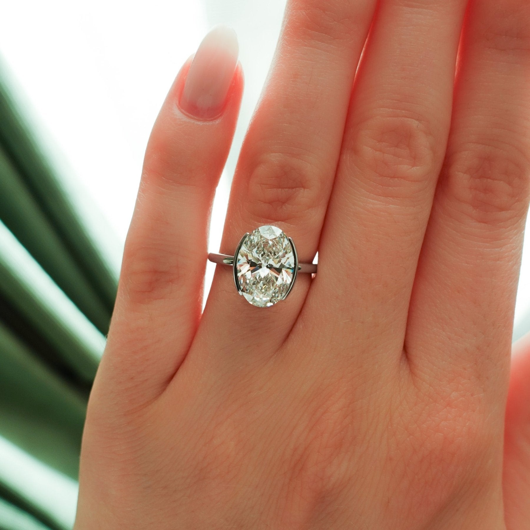 Half Bezel Solitaire Engagement Ring With Oval Cut Diamond