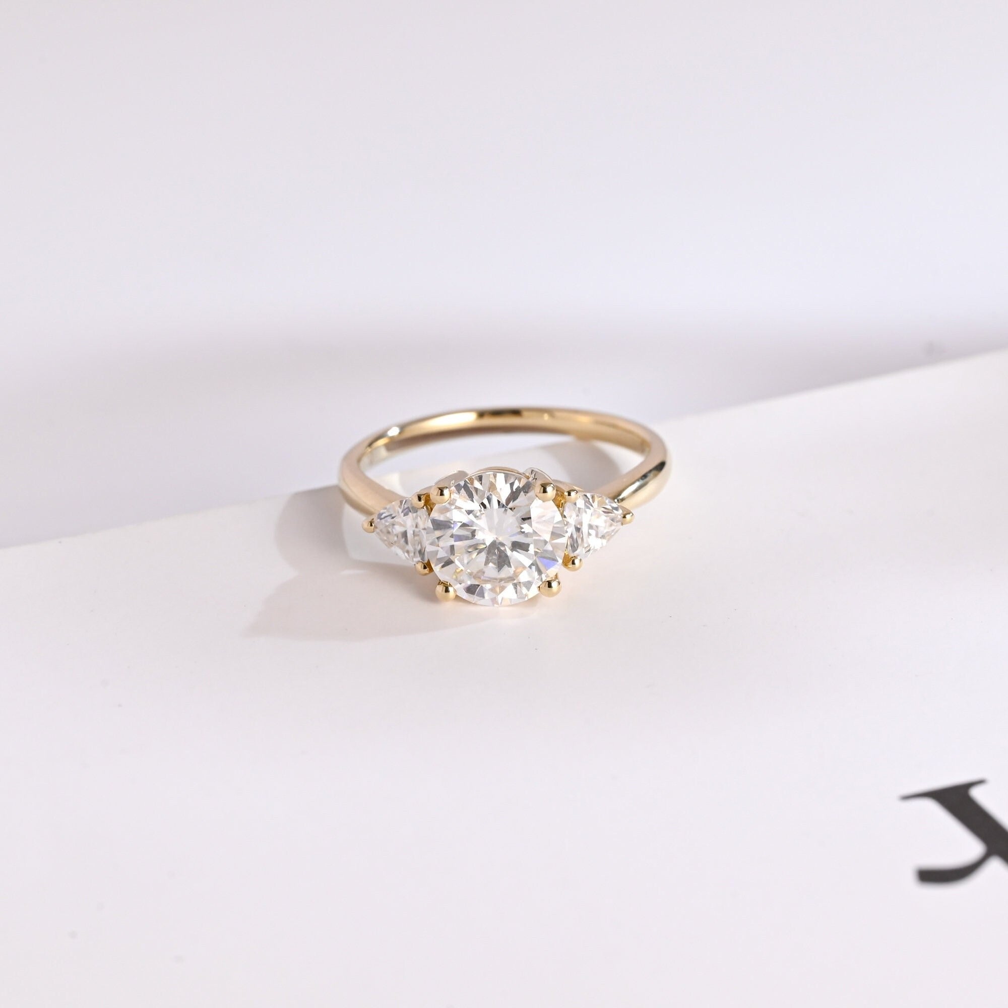 Solid Gold Three Stone Round Cut Moissanite Engagement Ring with Trillion Accent Main image