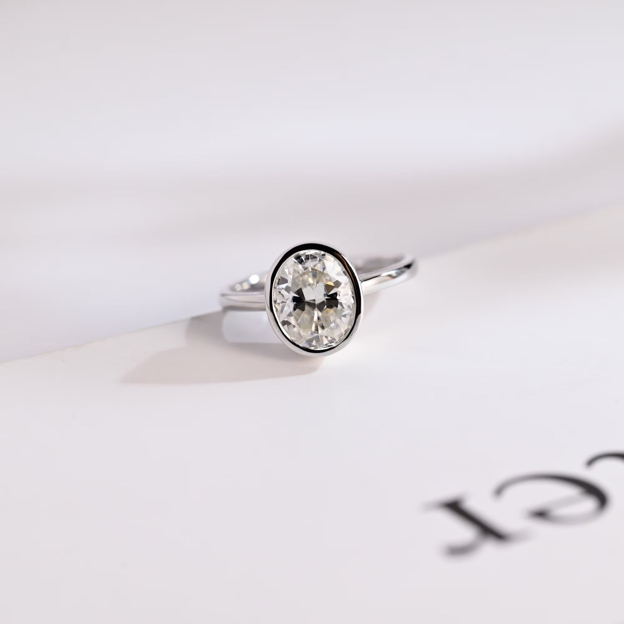 Solid Gold Oval Cut Crushed Ice Moissanite Engagement Ring with Bezel Main image