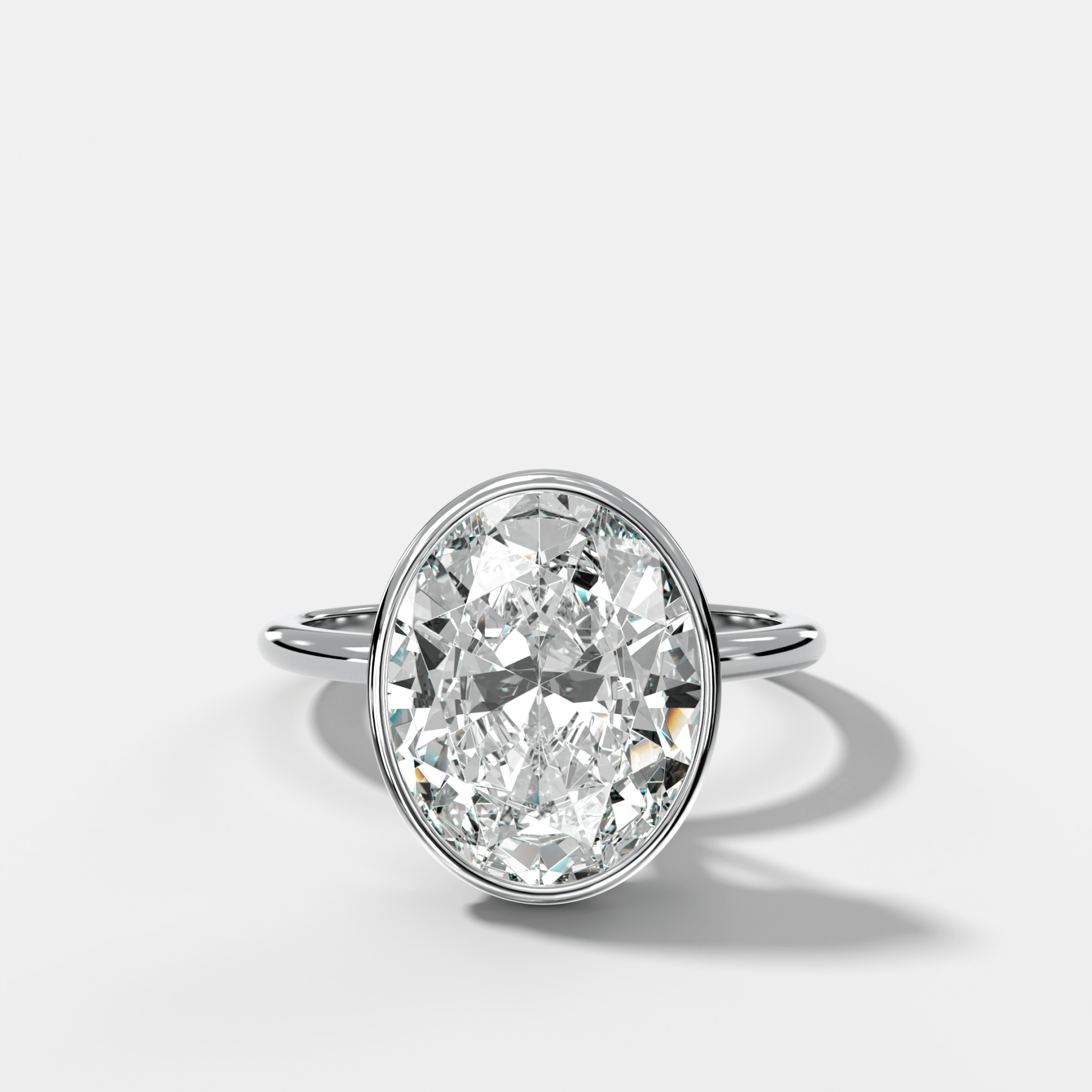 Penumbra Bezel Hidden Halo Engagement Ring with Oval Cut