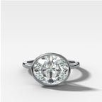 Penumbra Bezel Set Engagement Ring With East West Oval Cut