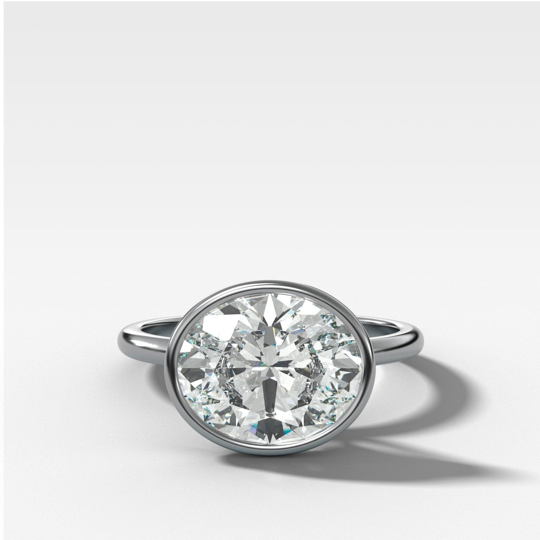 Penumbra Bezel Set Engagement Ring With East West Oval Cut