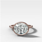 Penumbra Bezel Set Engagement Ring With East West Oval Cut