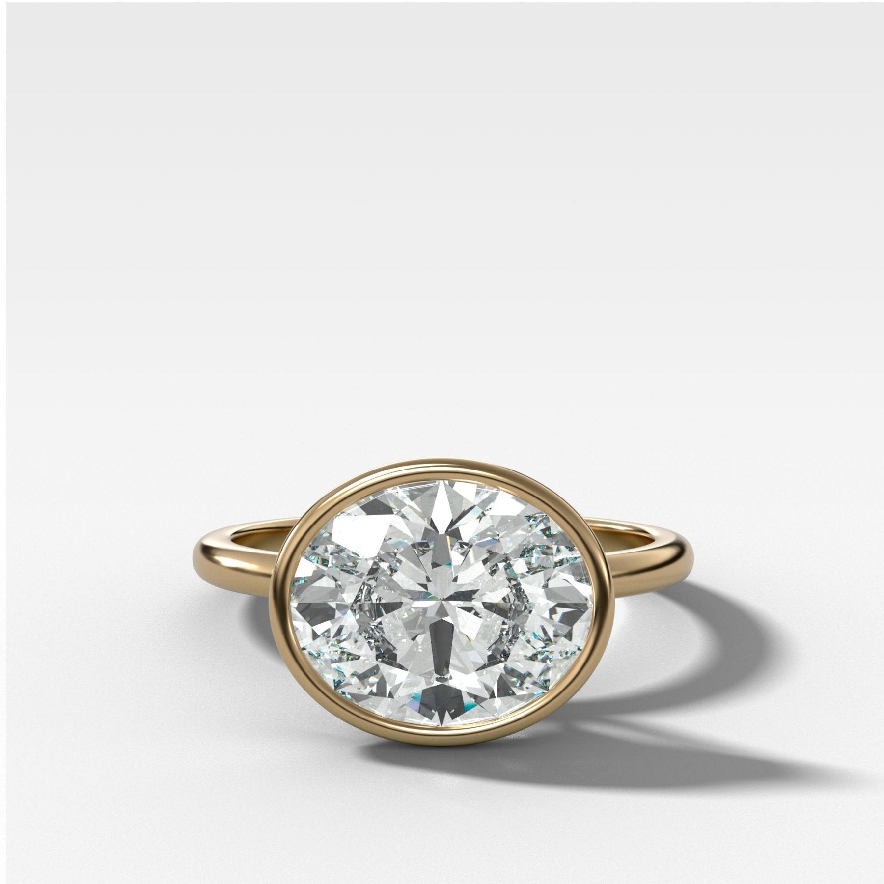 Penumbra Bezel Set Engagement Ring With East West Oval Cut