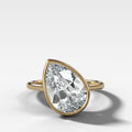 Penumbra Bezel Set Engagement Ring With Tilted Pear Cut