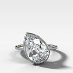 Penumbra Bezel Set Engagement Ring With Tilted Pear Cut