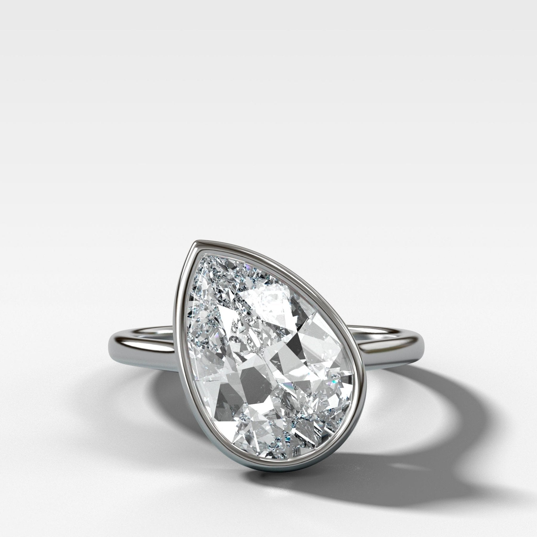 Penumbra Bezel Set Engagement Ring With Tilted Pear Cut