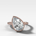 Penumbra Bezel Set Engagement Ring With Tilted Pear Cut