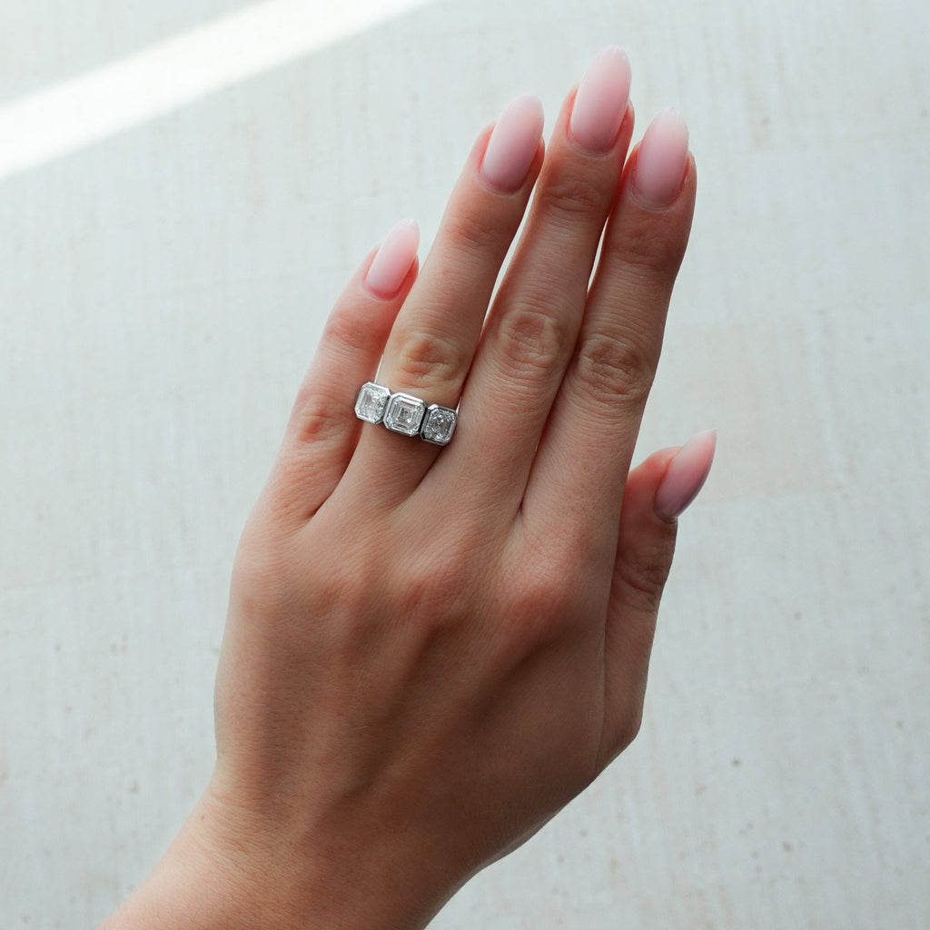 Penumbra Bezel Triad Engagement Ring With Asscher Cut Diamonds