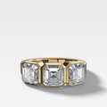 Penumbra Bezel Triad Engagement Ring With Asscher Cut Diamonds