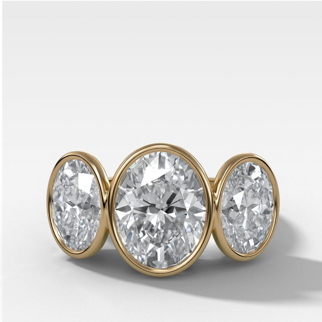 Penumbra Bezel Triad Engagement Ring With Oval Cut Diamonds