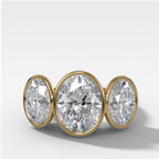 Penumbra Bezel Triad Engagement Ring With Oval Cut Diamonds