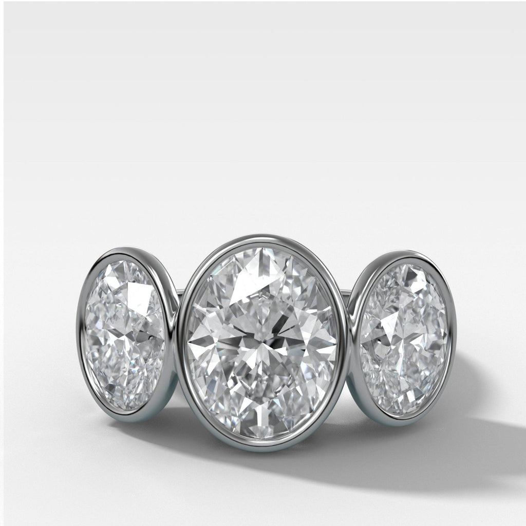 Penumbra Bezel Triad Engagement Ring With Oval Cut Diamonds