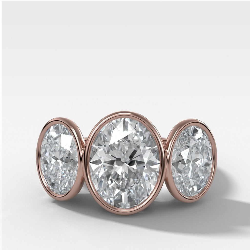 Penumbra Bezel Triad Engagement Ring With Oval Cut Diamonds