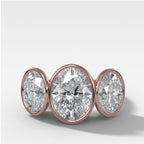 Penumbra Bezel Triad Engagement Ring With Oval Cut Diamonds
