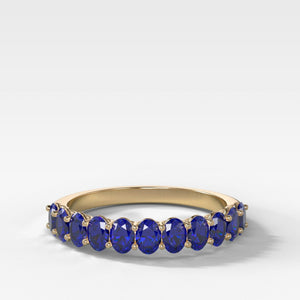 Petite Shared Prong Wedding Band with Blue Sapphire Oval Gemstones
