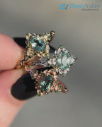 Briar rose floral halo with oval lab grown green sapphire engagement ring