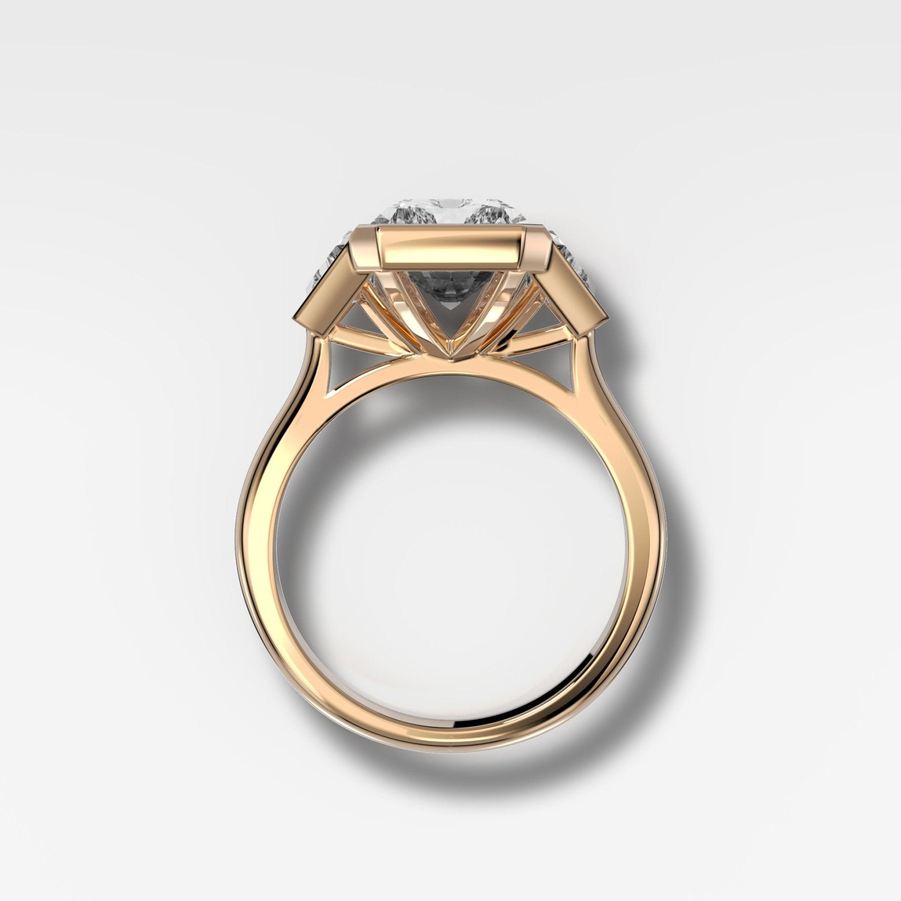 Three Stone Bezel Set Engagement Ring with Trapezoid Side Diamonds and an Elongated Radiant Cut