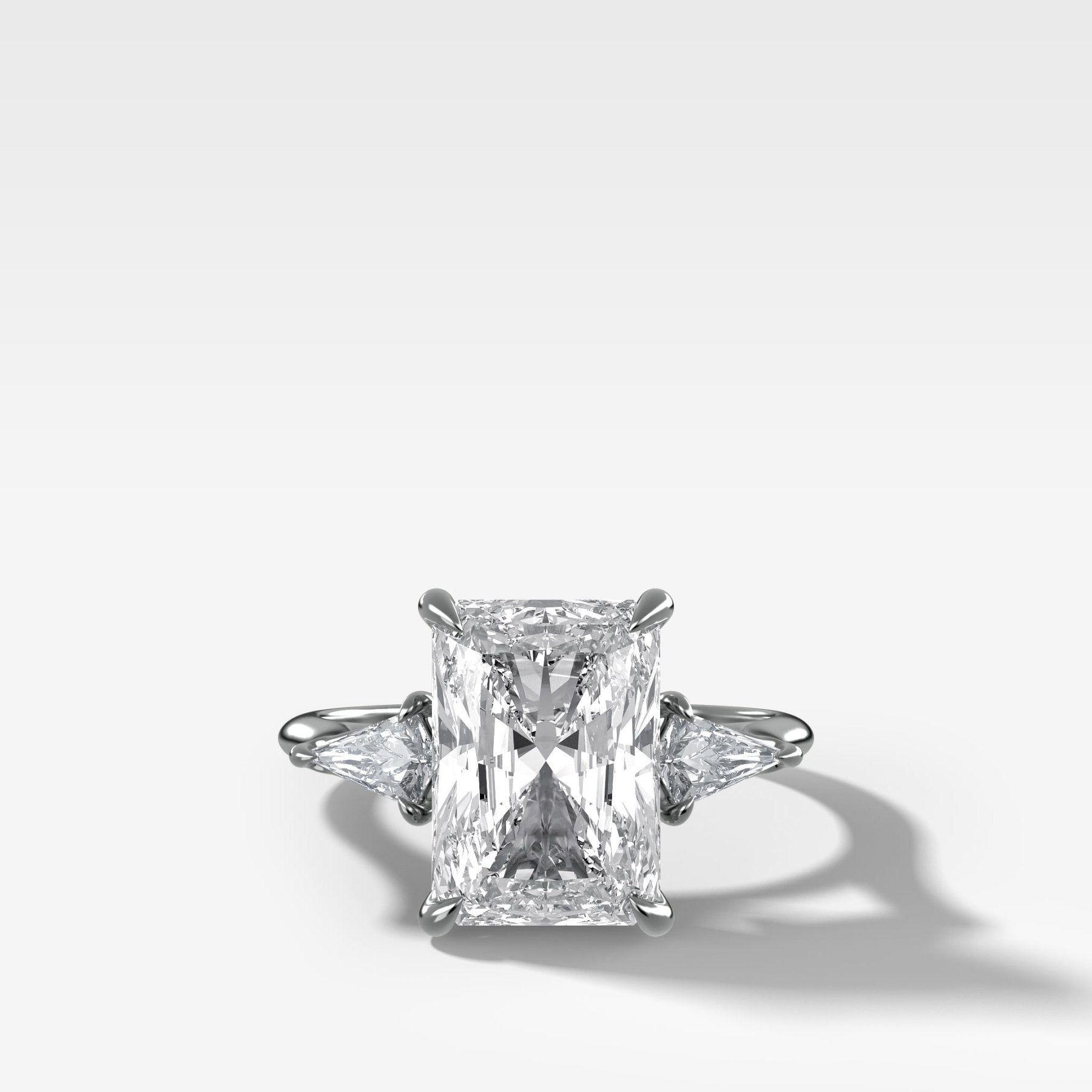 Three Stone Engagement Ring With Kite Side Stones and Elongated Radiant Cut Diamond