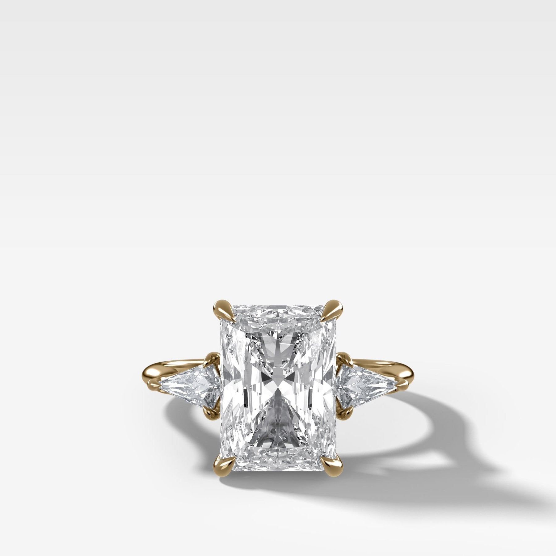Three Stone Engagement Ring With Kite Side Stones and Elongated Radiant Cut Diamond