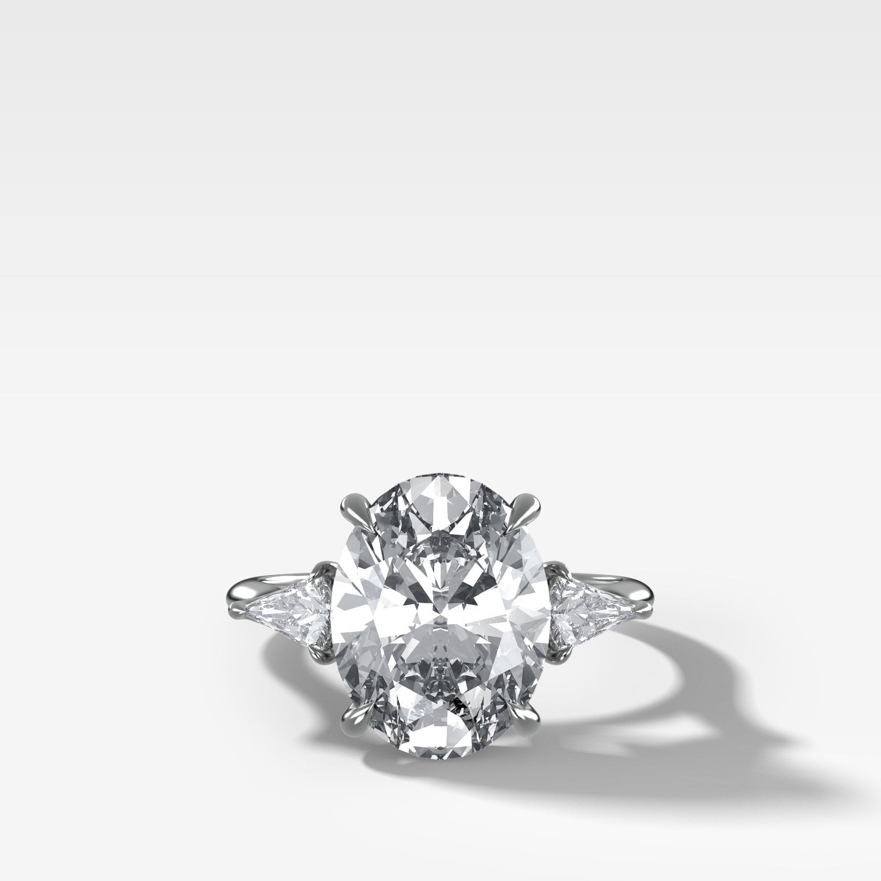 Three Stone Engagement Ring With Kite Side Stones and Oval Cut Diamond