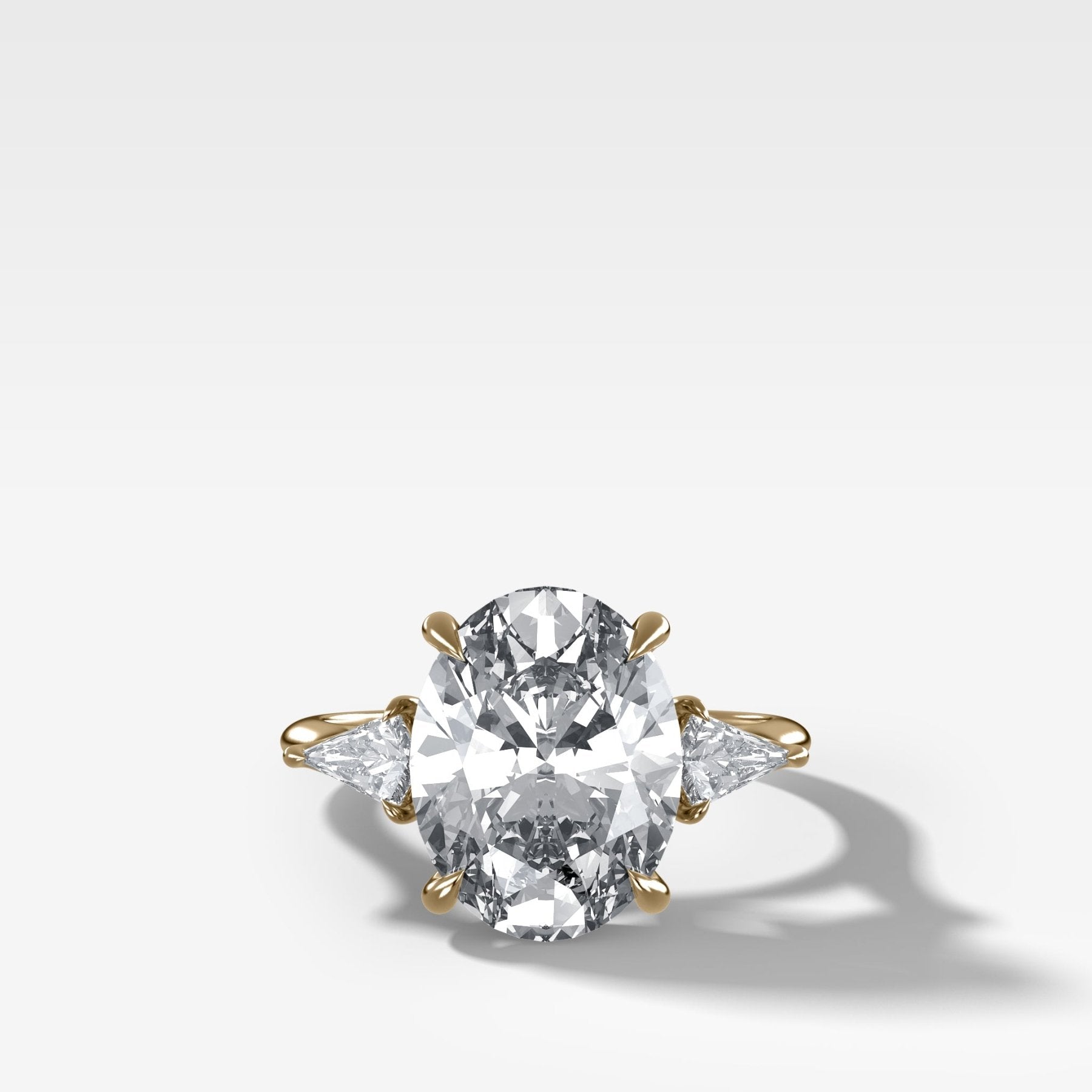 Three Stone Engagement Ring With Kite Side Stones and Oval Cut Diamond