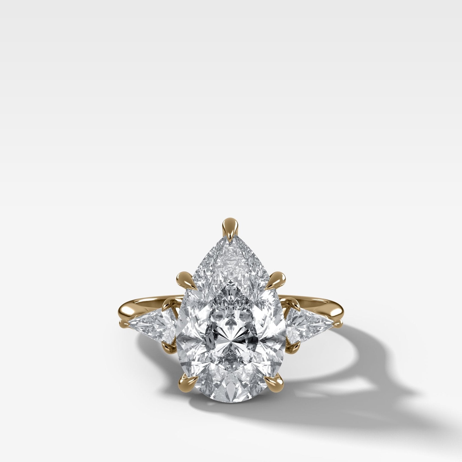 Three Stone Engagement Ring With Kite Side Stones and Pear Cut Diamond