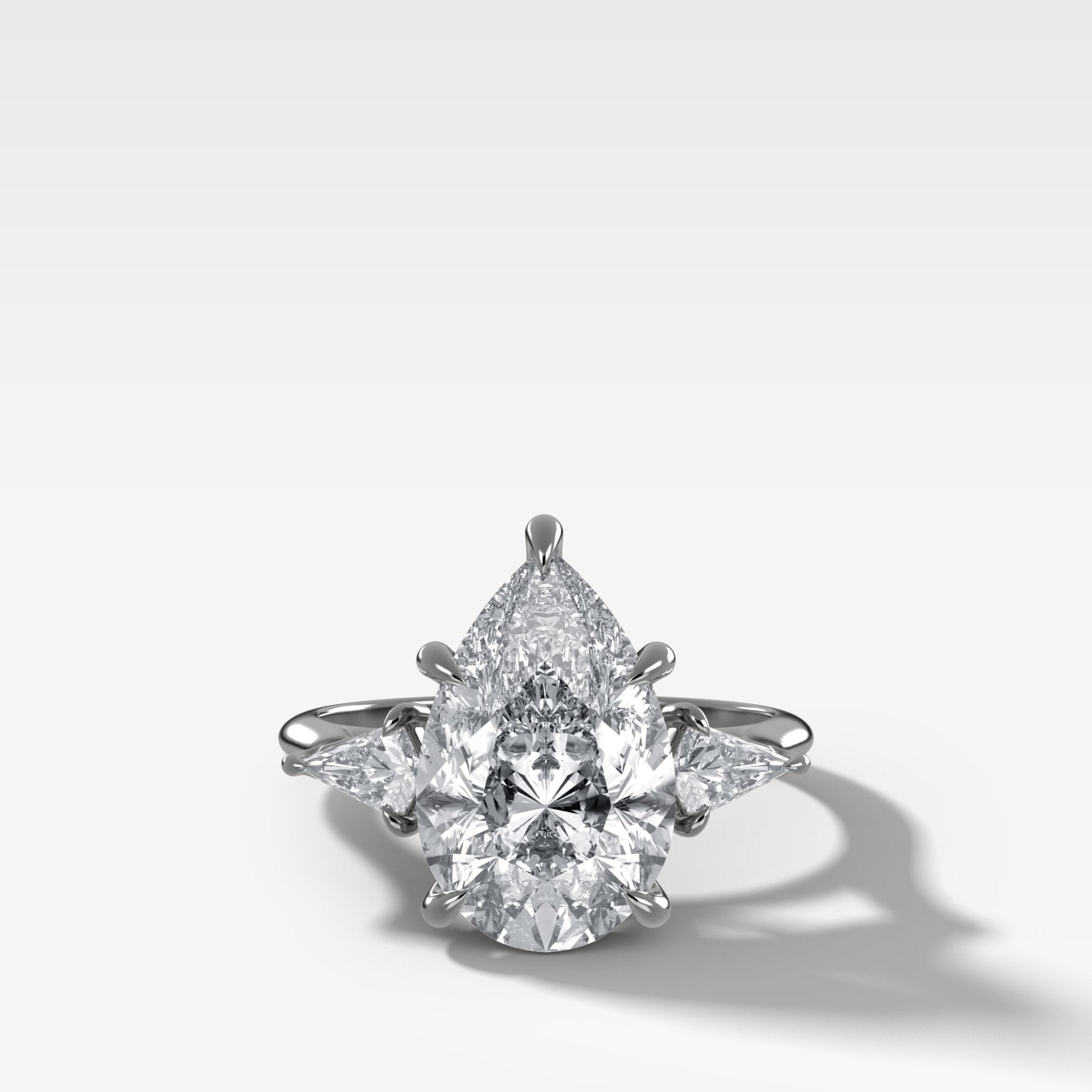 Three Stone Engagement Ring With Kite Side Stones and Pear Cut Diamond