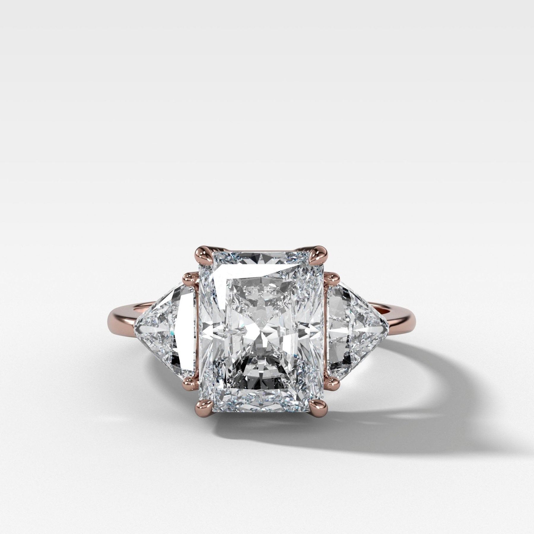 Three Stone Engagement Ring with Shield Side Stones and an Elongated Radiant cut Diamond