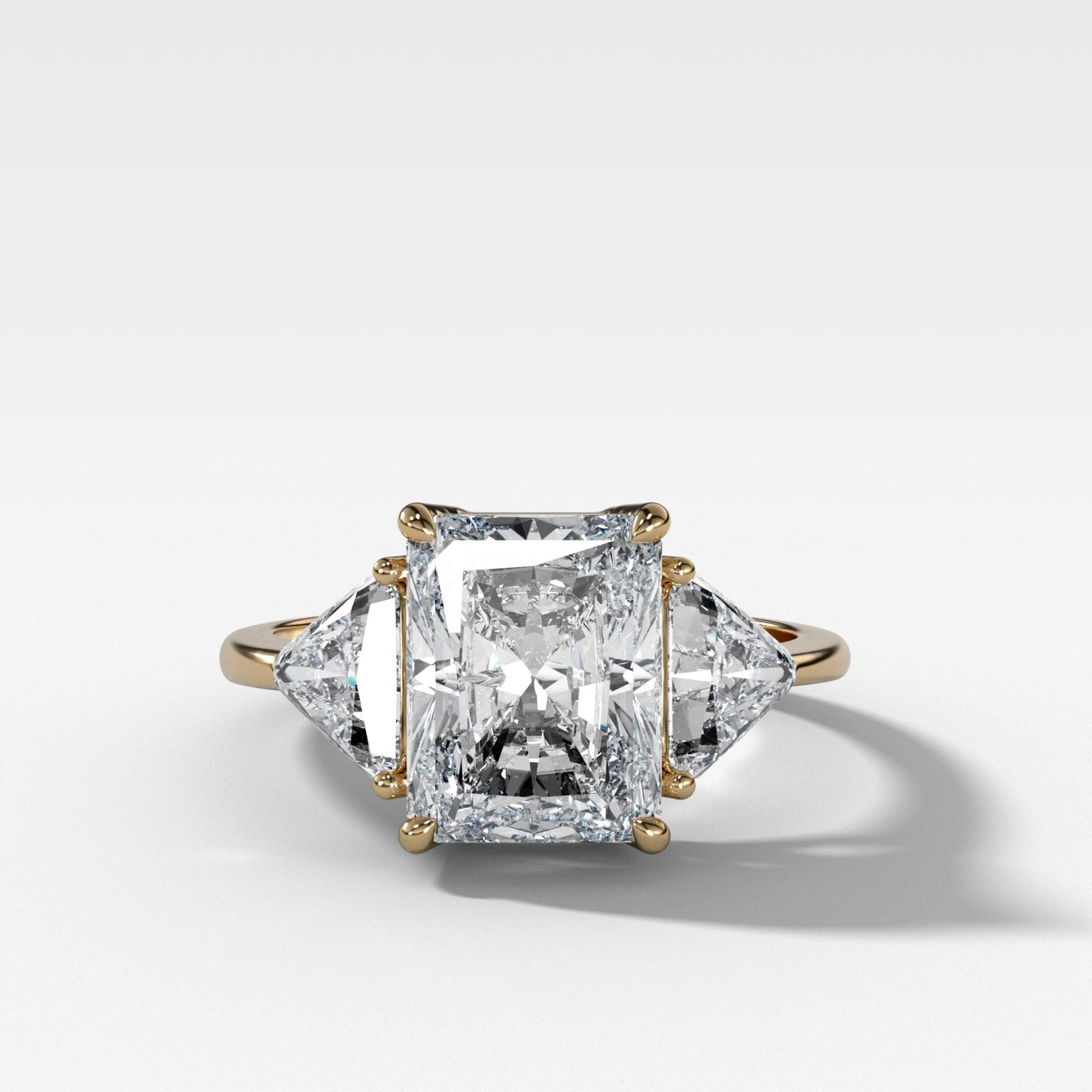 Three Stone Engagement Ring with Shield Side Stones and an Elongated Radiant cut Diamond
