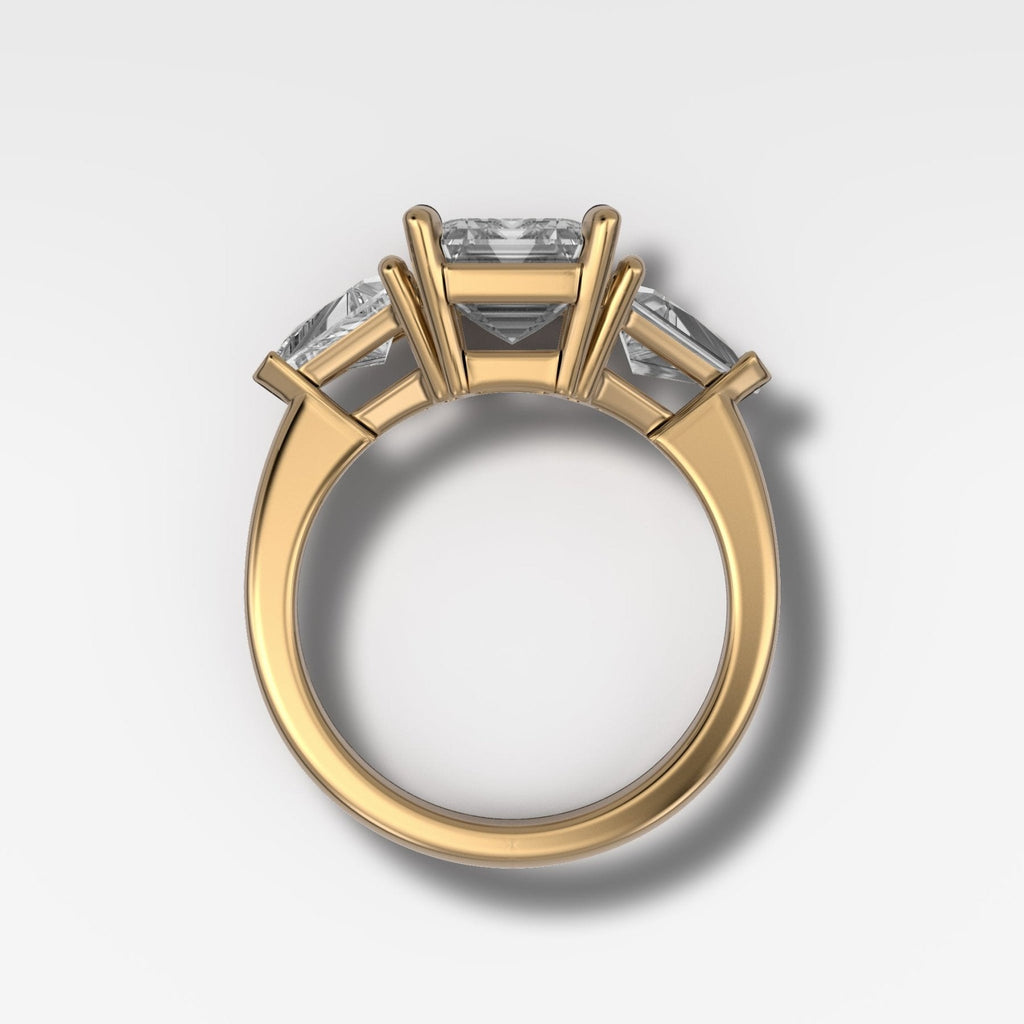 Three Stone Engagement Ring with Shield Side Stones and an Emerald Cut Diamond