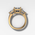 Three Stone Engagement Ring with Shield Side Stones and an Emerald Cut Diamond