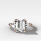 Three Stone Engagement Ring with Shield Side Stones and an Emerald Cut Diamond
