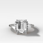 Three Stone Engagement Ring with Shield Side Stones and an Emerald Cut Diamond