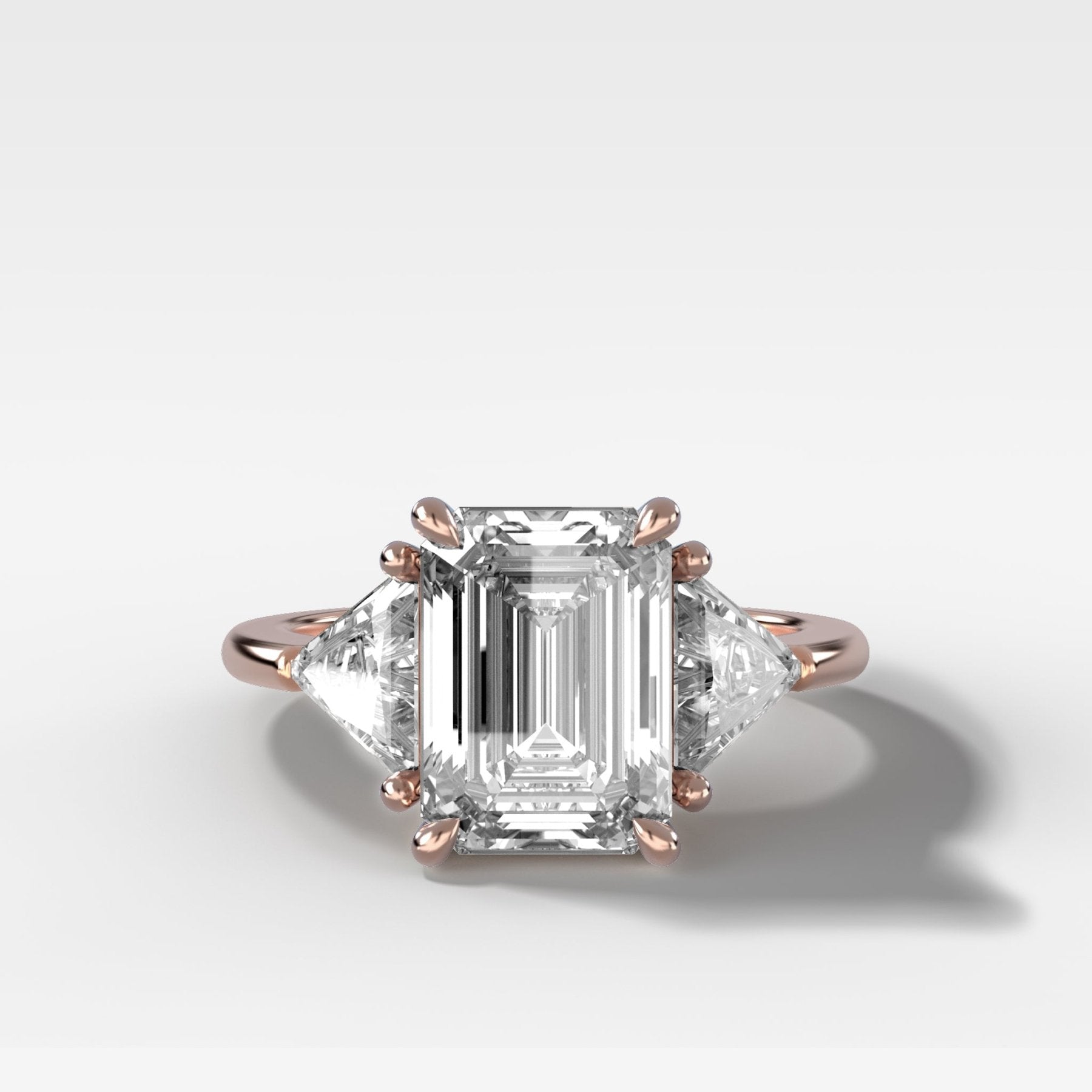 Three Stone Engagement Ring with Shield Side Stones and an Emerald Cut Diamond