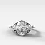 Three Stone Engagement Ring with Shield Side Stones and an Oval cut Diamond