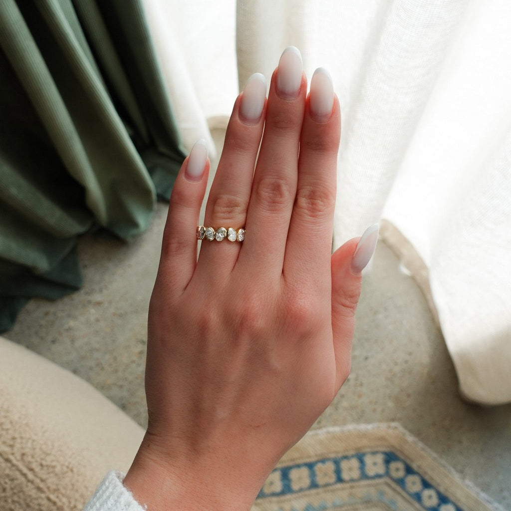 Tilted Bezel Set Wedding Band with Oval Cuts